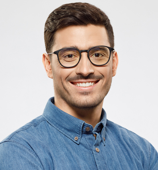 a man wearing glasses posing for the camera